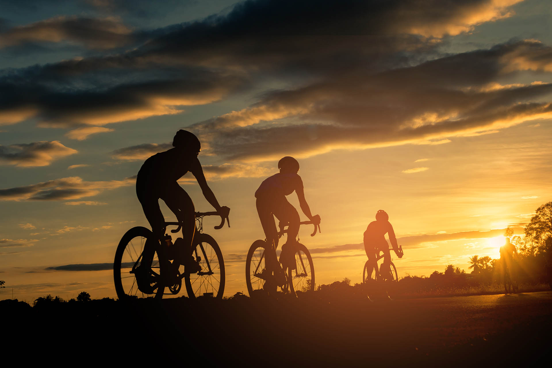 Rad2 0028 silhouette people riding bicycles against sky sunset